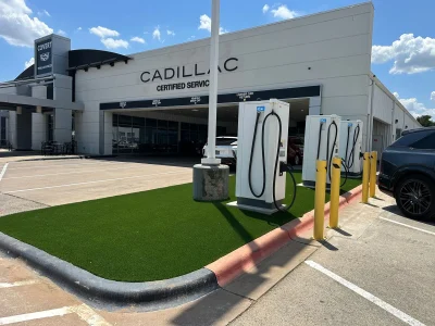 Commercial artificial turf around EV charging stations at an automotive service center in Austin, Texas